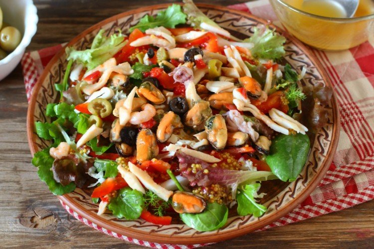 Свежий салат с морским коктейлем, овощами и зеленью